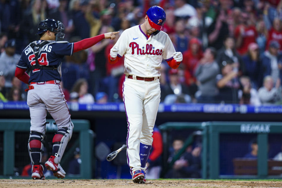 Philadelphia Phillies' Rhys Hoskins, right, reacts to striking out to end the seventh inning of a baseball game against the Atlanta Braves, Saturday, Sept. 24, 2022, in Philadelphia. The Braves won 6-3. (AP Photo/Chris Szagola)