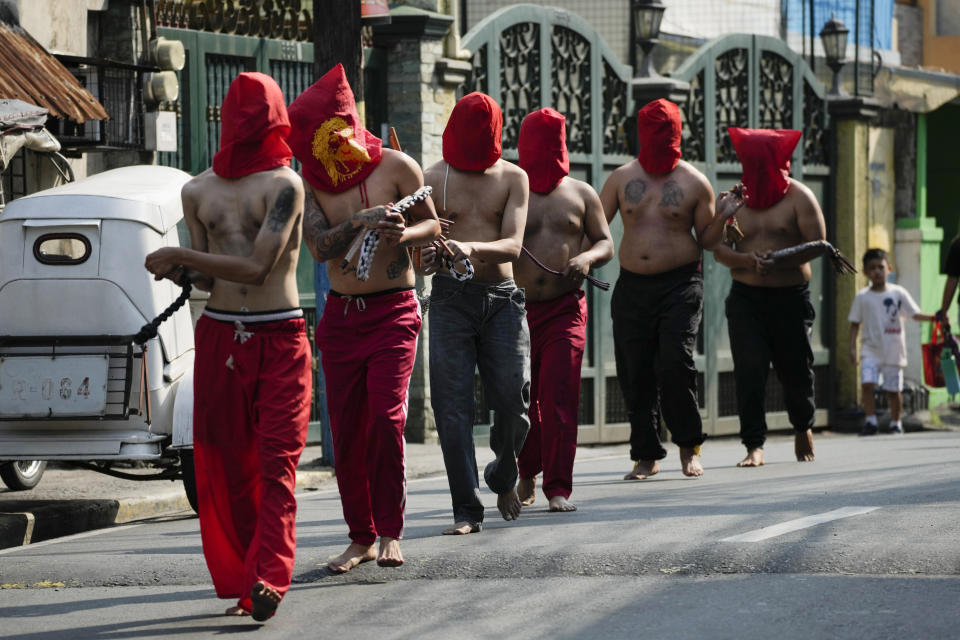 Hooded Filipino flagellants walk along a street as part of Maundy Thursday rituals to atone for sins or fulfill vows for an answered prayer on April 6, 2023 at Mandaluyong city, Philippines. COVID restrictions the past years have prevented crowds and devotees in participating in bizarre lenten rituals, a practice which have been opposed by the church in this predominantly Roman Catholic country. (AP Photo/Aaron Favila)