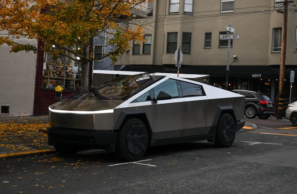 Tesla Cybertruck parked under a tree