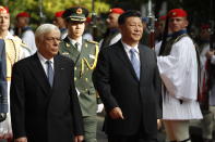 China's President Xi Jinping, centre and his Greek counterpart Prokopis Pavlopoulos, left, inspect the guard of honor by Evzones, the Greek Presidential guards, outside the Presidential palace in Athens, Monday, Nov. 11, 2019. Xi Jinping is in Greece on a two-day official visit. (AP Photos/Thanassis Stavrakis)