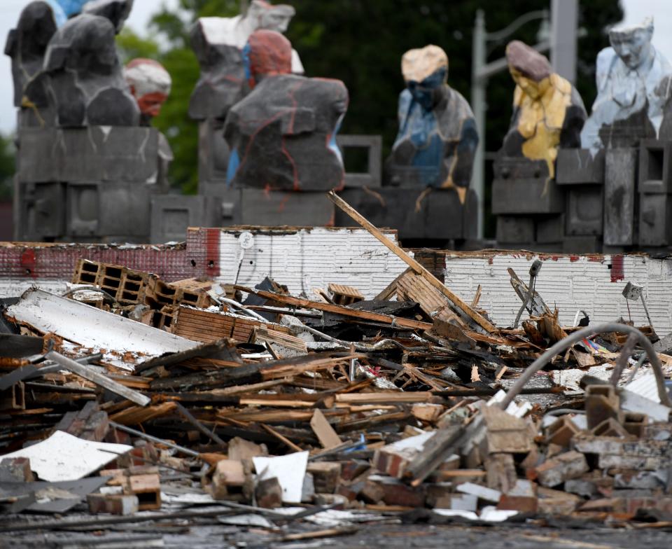 Workers with The Joseph A. Jeffries Co. demolish the former ArtsinStark office building at the corner of Ninth Street and Cleveland Avenue NW. The site will be part of a green space and park project scheduled for completion next summer.