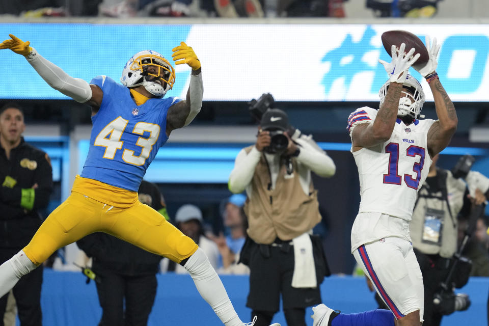 Buffalo Bills wide receiver Gabe Davis (13) makes a catch past Los Angeles Chargers cornerback Michael Davis (43) during the second half of an NFL football game Saturday, Dec. 23, 2023, in Inglewood, Calif. (AP Photo/Ashley Landis)