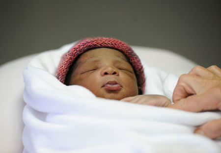 A newborn baby called Miracle, who was born on board, is seen inside the clinic of the Aquarius, in the central Mediterranean Sea, May 26, 2018. Picture taken May 26, 2018. REUTERS/Guglielmo Mangiapane