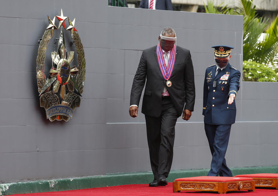 United States Defense Secretary Lloyd Austin, left, arrives at Camp Aguinaldo military camp escorted by Philippine Air Force Lieutenant General Erickson Gloria in Quezon City, Metro Manila, Philippines Friday, July 30, 2021. Austin is visiting Manila to hold talks with Philippine officials to boost defense ties and possibly discuss the The Visiting Forces Agreement between the US and Philippines. (Rolex dela Pena/Pool Photo via AP)