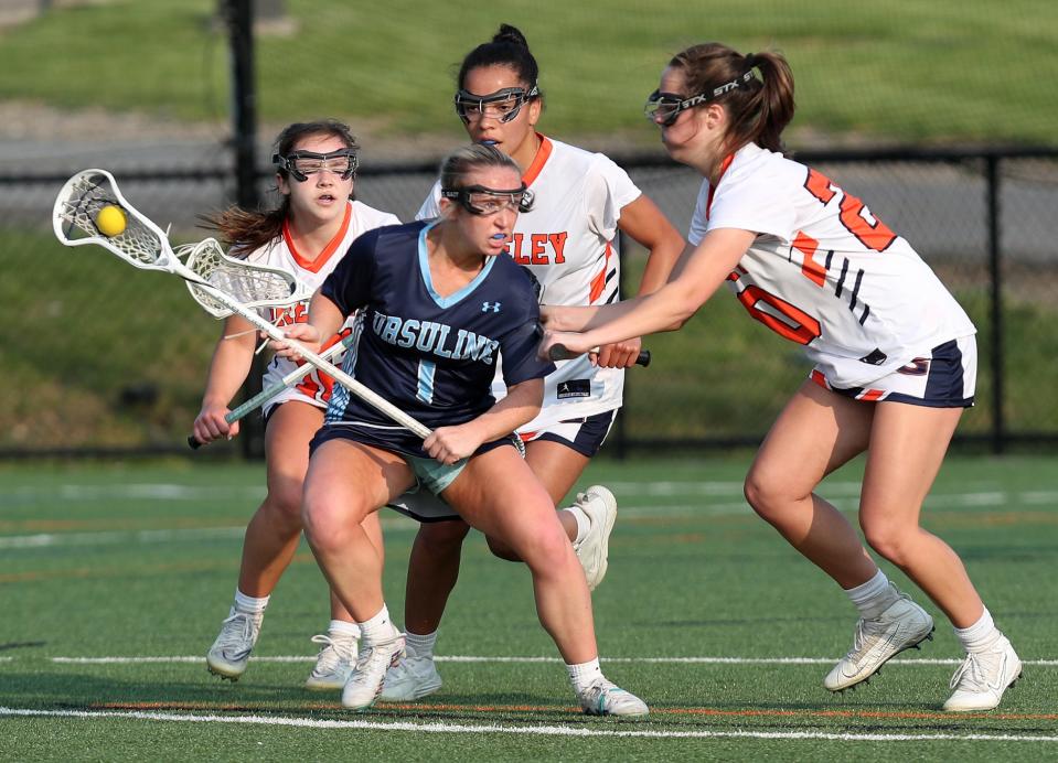 Ursuline's Maddy Mobilia (1) tries to get around Greeley defenders during girls lacrosse Class A semifinal at Horace Greeley High School in Chappaqua May 23, 2023. Greeley won the game 11-8.