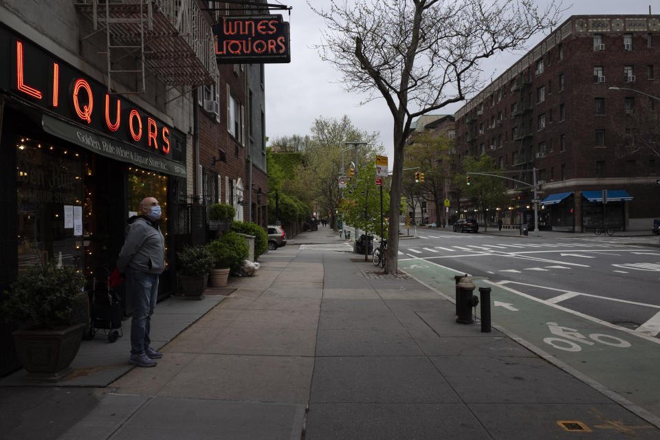 FILE - A man waits his turn to enter Golden Rule Wine & Liquor on Hudson Street, April 30, 2020, in New York. Towns in New York that have never repealed Prohibition-era rules banning the sale of alcohol would be forced to lift their liquor restrictions under a bill moving through the state legislature. The bill’s sponsor argues it will spur business growth in seven towns that still have booze bans. (AP Photo/Mark Lennihan, File)