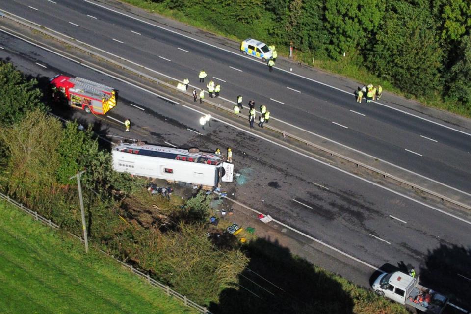 Emergency services at the scene of a coach crash on the M53 motorway (Peter Byrne/PA) (PA Wire)