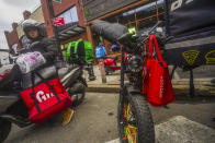 A food delivery worker prepares to ride off after a pickup from a fast-food restaurant on Brooklyn's Flatbush Avenue, Mondfy, Jan. 29, 2024, in New York. Recent city ordinances in New York and Seattle increased minimum wage protections for app-based food delivery workers. (AP Photo/Bebeto Matthews)