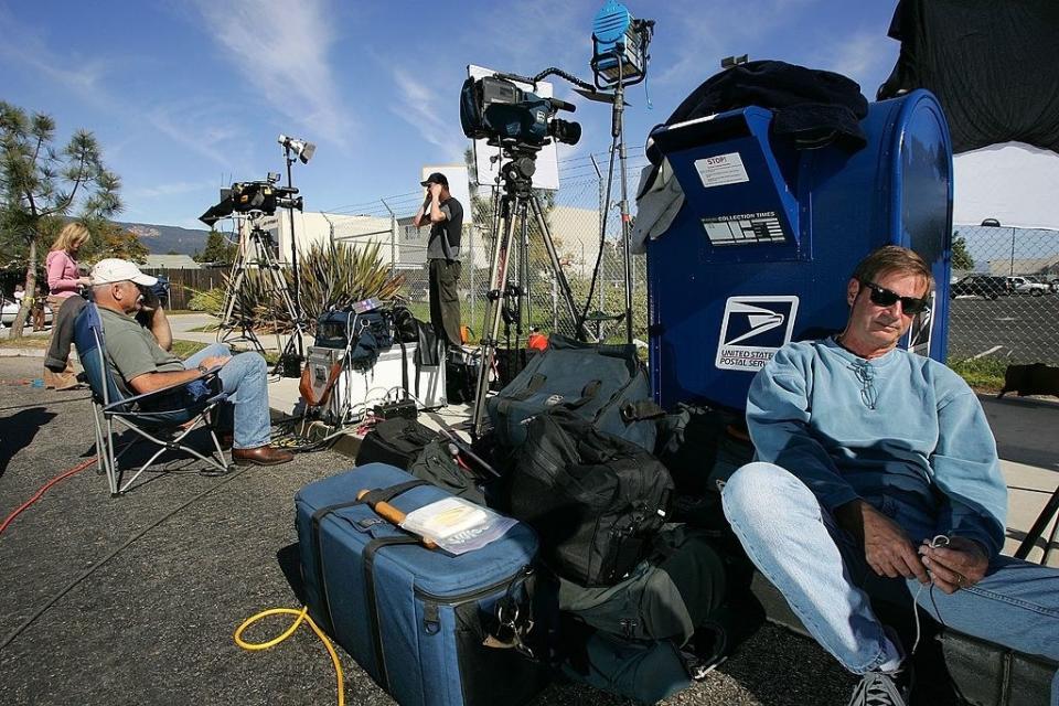 Camera crew wait outside a postal office mail facility