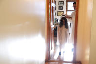 Rabbi Shlomo Segal, right, places a hat on his daughter Rayna's head as she enters the room in a burst of sunlight dressed as the ancient prophet "Elijah" during a virtual Passover seder in the Sheepshead Bay section of Brooklyn during the current coronavirus outbreak, Wednesday, April 8, 2020, in New York. According to Jewish tradition, during the Passover seder service, Elijah will arrive as a surprise or unknkown guest to herald the advent of the Messiah. During the Seder dinner, biblical verses are read while the door is briefly opened to welcome Elijah. The seder dinner commemorates and recalls the historical redemption of Jews from Egyptian bondage and foretells their future redemption. (AP Photo/Kathy Willens)