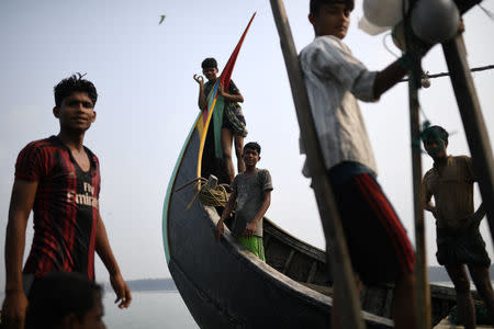 Rohingya refugees crew a fishing boat in the Bay of Bengal near Cox's Bazaar, Bangladesh, March 24, 2018. REUTERS/Clodagh Kilcoyne