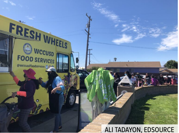 Families line up in Richmond to receive free summer meals provided by West Contra Costa Unified from a food truck the district purchased with grant funds aimed at upgrading school kitchen infrastructure
