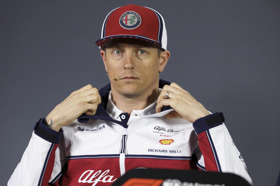 Alfa Romeo driver Kimi Raikkonen of Finland adjusts his jacket collar during a press conference at the Shanghai International Circuit ahead of the Chinese Formula One Grand Prix in Shanghai, China, Thursday, April 11, 2019. (AP Photo/Ng Han Guan)