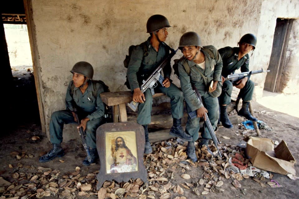 Salvadoran troopers rest on the porch of a deserted farm house between Suchitoto and San José Guayabal, El Salvador, in March 1981. (Pat Hamilton / AP)