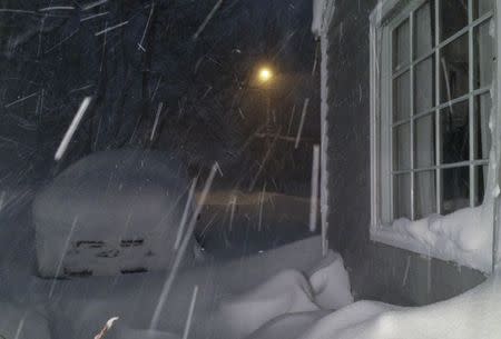 Heavy Lake Effect snow falls and accumulates on a vehicle in the driveway of a home in Orchard Park, New York, November 18, 2014. REUTERS/Judith Gros