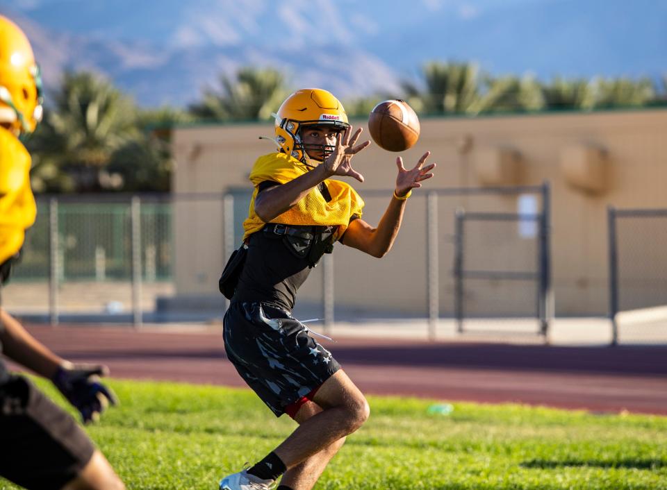 Coachella Valley's Ivan Garza makes a catch during practice at Coachella Valley High School in Thermal, Calif., Friday, Aug. 4, 2023. 