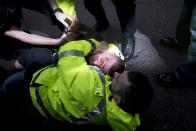 Police officers detain a man following a protest by the UK branch of the German group 'Pegida', in the city centre of Newcastle upon Tyne, Northern England on February 28, 2015.The German-based PEGIDA movement, which opposes what it calls the "Islamisation" of Europe, was staging its first demonstration on British soil on Saturday. AFP PHOTO / OLI SCARFF (Photo credit should read OLI SCARFF/AFP via Getty Images)