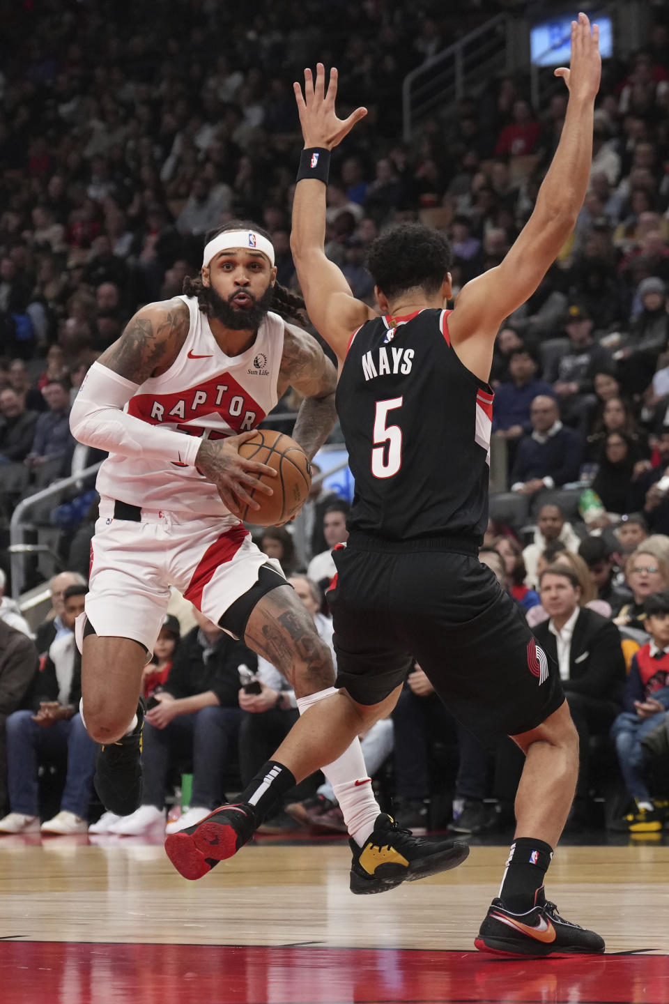 Toronto Raptors guard Gary Trent Jr. (33) heads towards the basket as Portland Trail Blazers guard Skylar Mays (5) defends during the first half of an NBA basketball game game in Toronto, Monday, Oct. 30, 2023. (Nathan Denette/The Canadian Press via AP)