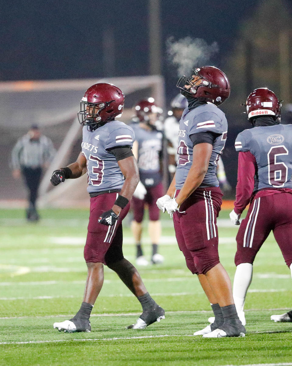 Benedictine's Cole Semien flexes after bringing down Spalding quarterback Curt Clark for a loss during Friday night's state playoff game at Memorial Stadium.