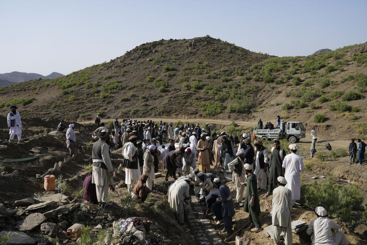 Afghans burry relatives killed in an earthquake to a burial site l in Gayan village, in Paktika province, Afghanistan, Thursday, June 23, 2022. A powerful earthquake struck a rugged, mountainous region of eastern Afghanistan early Wednesday, flattening stone and mud-brick homes in the country's deadliest quake in two decades, the state-run news agency reported. (AP Photo/Ebrahim Nooroozi)