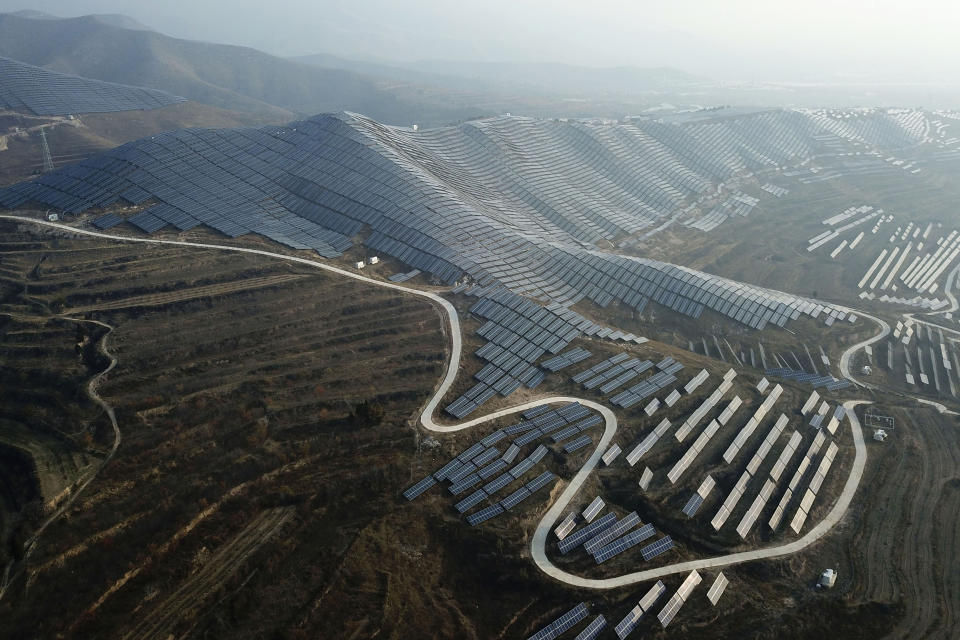 FILE - This Nov. 28, 2019 photo shows a solar panel installation in Ruicheng County in central China's Shanxi Province. Two new analyses released on Thursday, Nov. 4, 2021 trim projections of future global warming by a few tenths of a degree. Those however look at quite optimistic scenarios that might not come true. The big changes that factored in were from India and China and a new international pledge to reduce methane. Still, it's nowhere near the Paris goal. (AP Photo/Sam McNeil)