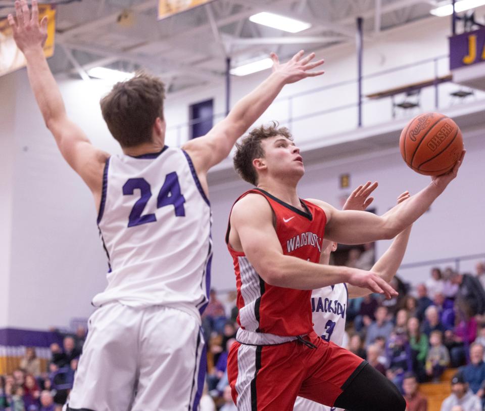 Wadsworth's Maxx Bosley shoots as Jackson's Kyle Monterrubio defends during a boys varsity basketball game at Jackson on Tuesday, Feb.13, 2024.