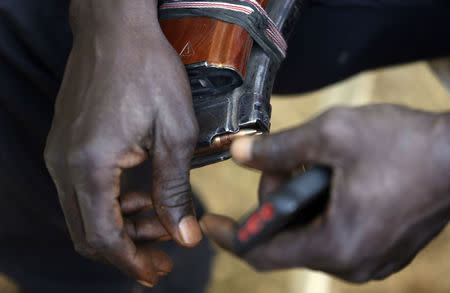 A leader of militia hunters helping the army to fight the Boko Haram insurgence in the northeast region of Nigeria, holds a magazine of bullets in his hands during an interview in Yola, Adamawa State January 14, 2015. REUTERS/Afolabi Sotunde