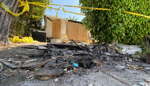 Charred debris and caution tape are seen at the site where Anne Heche crashed her car. (Photo: CHRIS DELMAS via Getty Images)