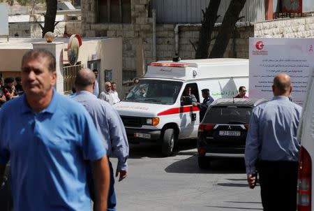 An ambulance transports the body of Jordanian writer Nahed Hattar to a medical facility after he was shot dead in Amman, Jordan, September 25, 2016. REUTERS/Muhammad Hamed