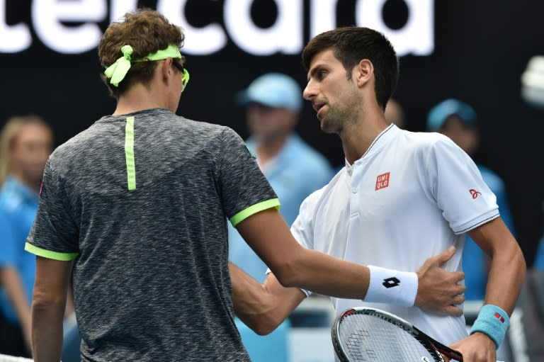 Serbia's Novak Djokovic (R) shakes hands with Uzbekistan's Denis Istomin after their men's singles second round match on day four of the Australian Open in Melbourne on January 19, 2017