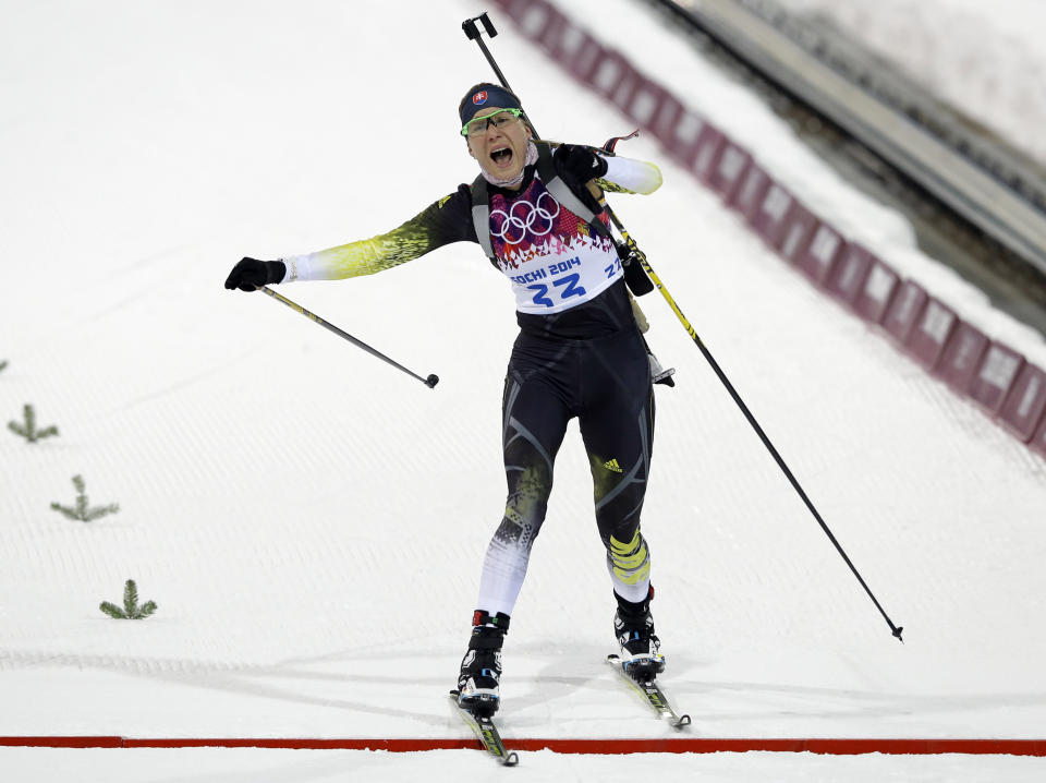 Slovakia's Anastasiya Kuzmina crosses the finish line to win the women's biathlon 7.5k sprint, at the 2014 Winter Olympics, Sunday, Feb. 9, 2014, in Krasnaya Polyana, Russia.