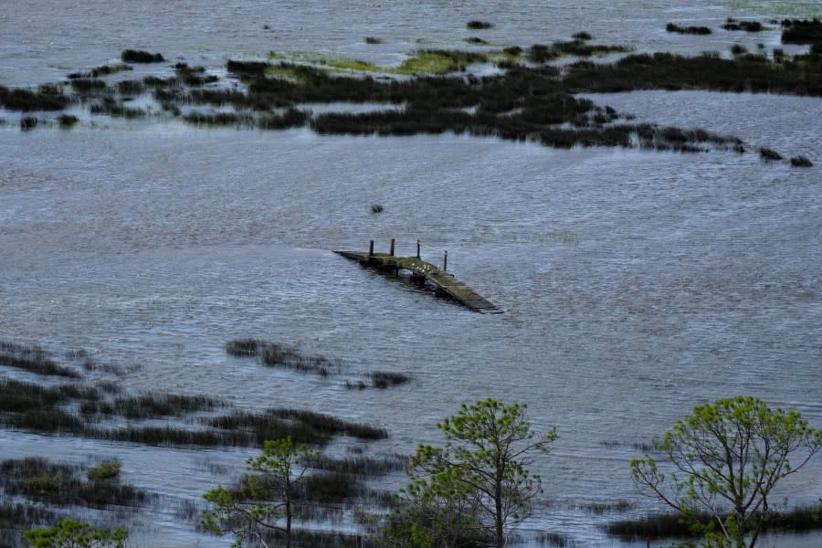 In this photo made in a flight provided by mediccorps.org, a pedestrian bridge is seen amidst storm flooding in Dekle Beach, Fla., following the passage of Hurricane Idalia, Wednesday, Aug. 30, 2023. (AP Photo/Rebecca Blackwell)