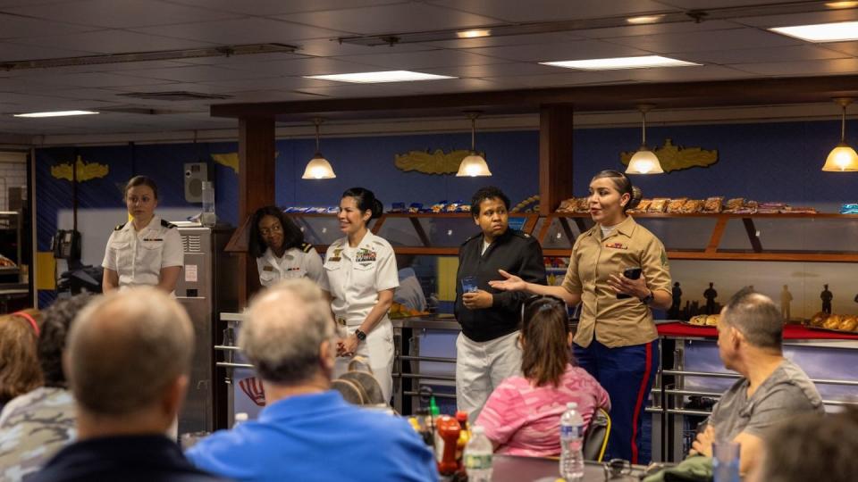 Sgt. Cristal Trejo answers questions about making the perfect hair bun during a question-and-answer panel with the Heart of the Hudson Girl Scouts aboard the Wasp on May 27. (Lance Cpl. Jessica J. Mazzamuto/Marine Corps)