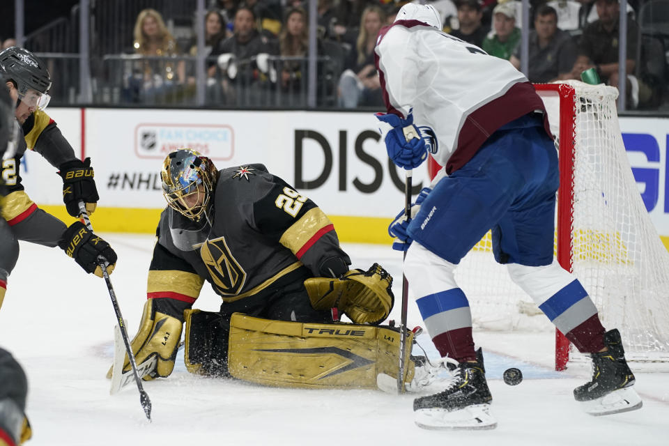 Vegas Golden Knights goaltender Marc-Andre Fleury (29) blocks a shot by Colorado Avalanche defenseman Cale Makar, right, during the first period in Game 4 of an NHL hockey Stanley Cup second-round playoff series Sunday, June 6, 2021, in Las Vegas. (AP Photo/John Locher)