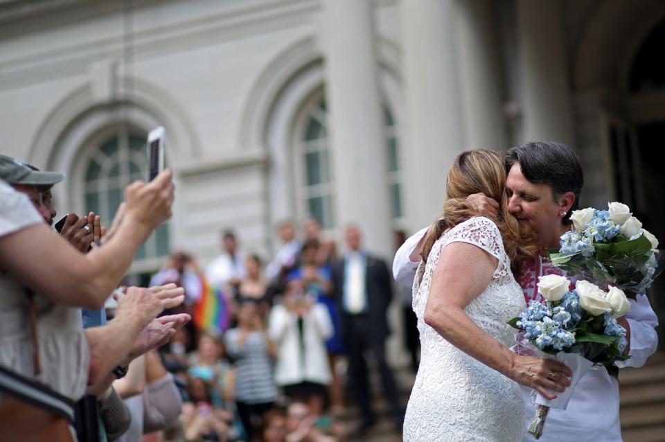 <p>A couple embraced before their wedding ceremony in NYC on June 26, 2015, the day the Supreme Court handed down a decision legalizing gay marriage in all 50 states.</p><p><strong>RELATED: </strong><a href="https://www.redbookmag.com/life/friends-family/a47167/easy-ways-to-help-out-on-family-volunteer-day/" rel="nofollow noopener" target="_blank" data-ylk="slk:10 Easy Ways Your Family Can Give Back Together;elm:context_link;itc:0;sec:content-canvas" class="link "><strong>10 Easy Ways Your Family Can Give Back Together</strong></a></p>