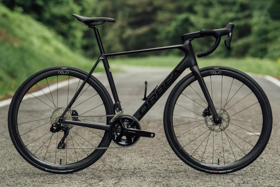 Orbea Orca OMR bike on a tarmac road with greenery in the background