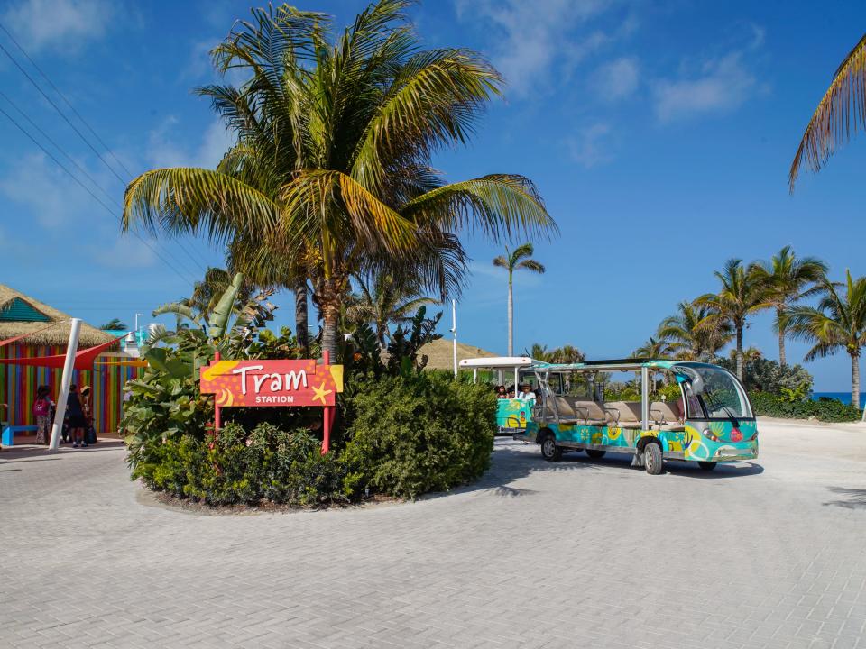 The tram station with palm trees on a partly cloudy day at CocoCay with blue skies