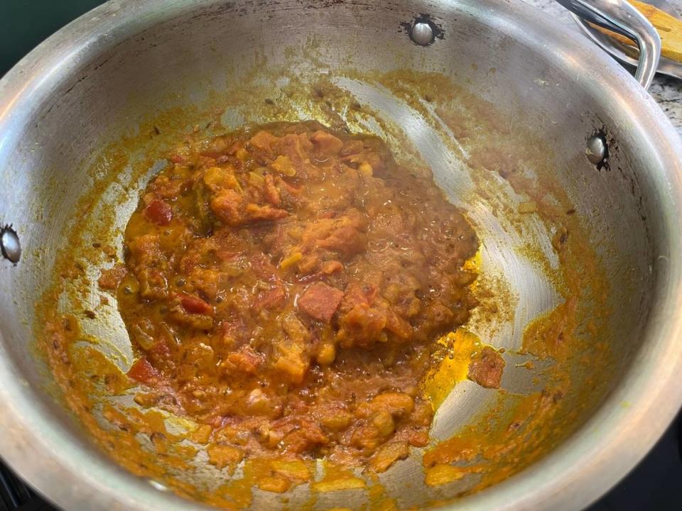 When oil starts to pool at the edges of the masala sauce, it has finished cooking. You can then mix it into the chicken and vegetable mixture and add heavy whipping cream to finish the dish. Heidi Finley/CharlotteFive
