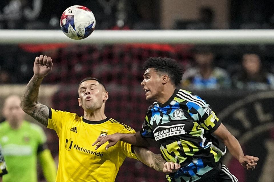 Columbus Crew forward Christian Ramírez and Atlanta United defender Caleb Wiley both try to head the ball.