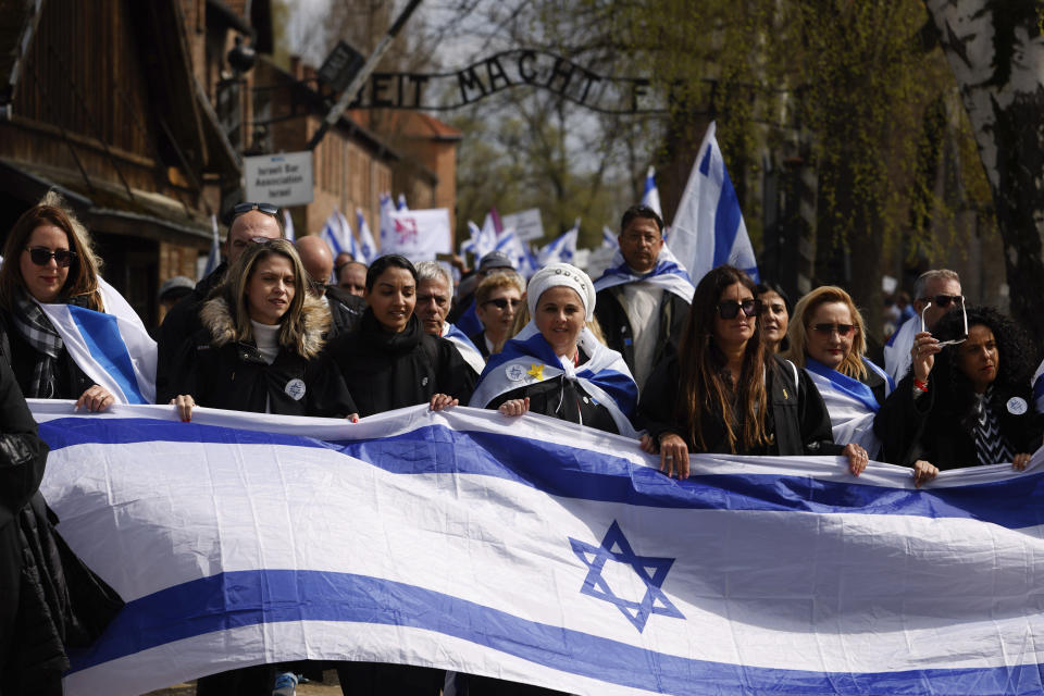 People gather to participate in the annual 'March of the Living', a trek between two former Nazi-run death camps, in Oswiecim, Poland, Tuesday, April 18, 2023 to mourn victims of the Holocaust and celebrate the existence of the Jewish state. (AP Photo/Michal Dyjuk)