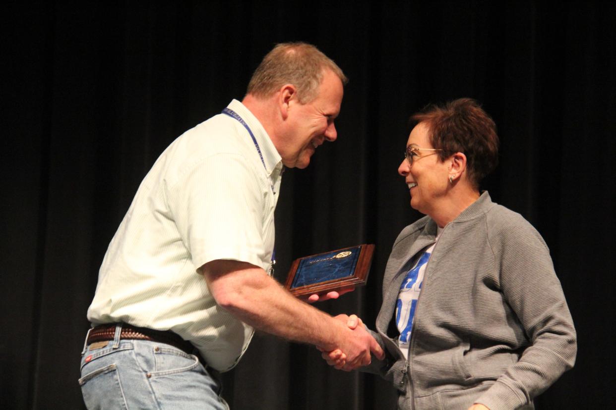 Kevin Vidergar awards the Rotary Teacher of the Year Award to Perry High School's Lori Meinecke on Wednesday, May 22, 2024.