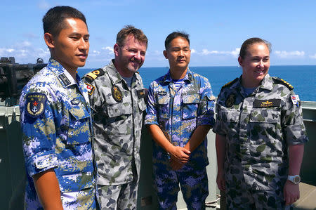 Royal Australian Navy officers stand with officers from the Chinese Navy aboard the Royal Australian Navy frigate HMAS Newcastle during Australia's largest maritime exercise 'Exercise Kakadu' being conducted off the coast of Darwin in northern Australia, September 8, 2018. Picture taken September 8, 2018. REUTERS/Jill Gralow