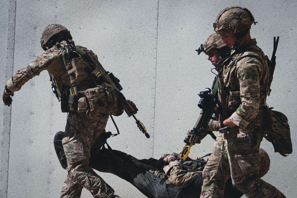 British Royal Marines carry casualty on stretcher