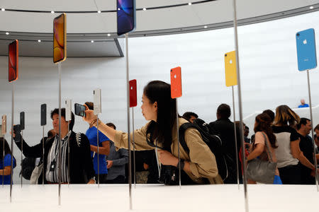 People take photos of the new Apple iPhones released following the product launch event at the Steve Jobs Theater in Cupertino, California, U.S. September 12, 2018. REUTERS/Stephen Lam