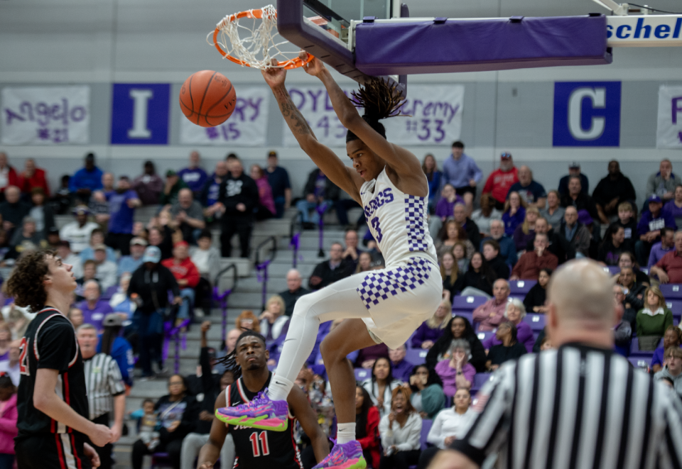 Barberton's De'Arion Holley with a two-hand slam dunk in the second half of a game against Kent Roosevelt on Feb. 9, 2024.