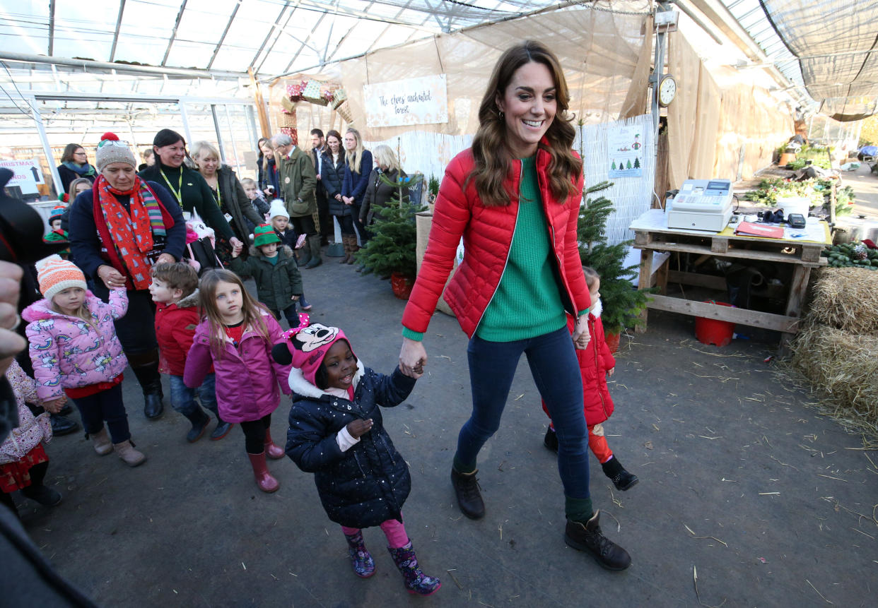 The Duchess of Cambridge leads children to pick a Christmas tree during a visit to Peterley Manor Farm in Buckinghamshire, Britain, on Dec. 4. (Photo: POOL/Reuters)