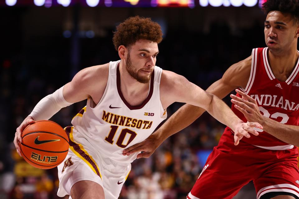 Feb 27, 2022; Minneapolis, Minnesota, USA; Minnesota Gophers forward Jamison Battle (10) drives to the basket as Indiana Hoosiers forward Trayce Jackson-Davis (23) guards him during the first half at Williams Arena.