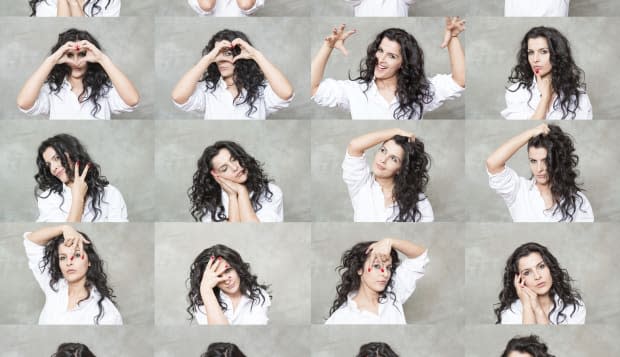 beautiful woman is making twenty different facial expressions