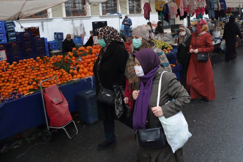 People shop at a local market in Fatih district in Istanbul