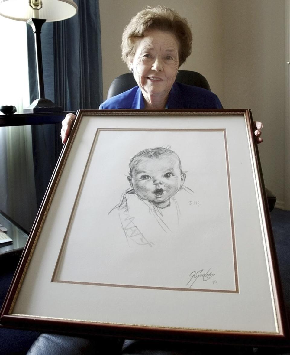 Ann Taylor Cook, poses at her Tampa, Fla., home Wednesday afternoon Feb. 4, 2004, with a copy of her photo that is used on all Gerber baby food products